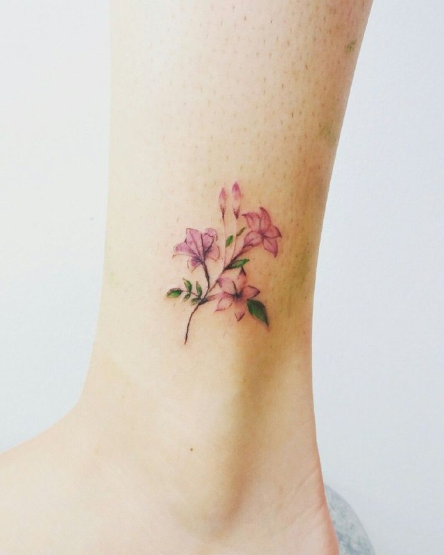 Colorful jasmine tattoo on the shin for women