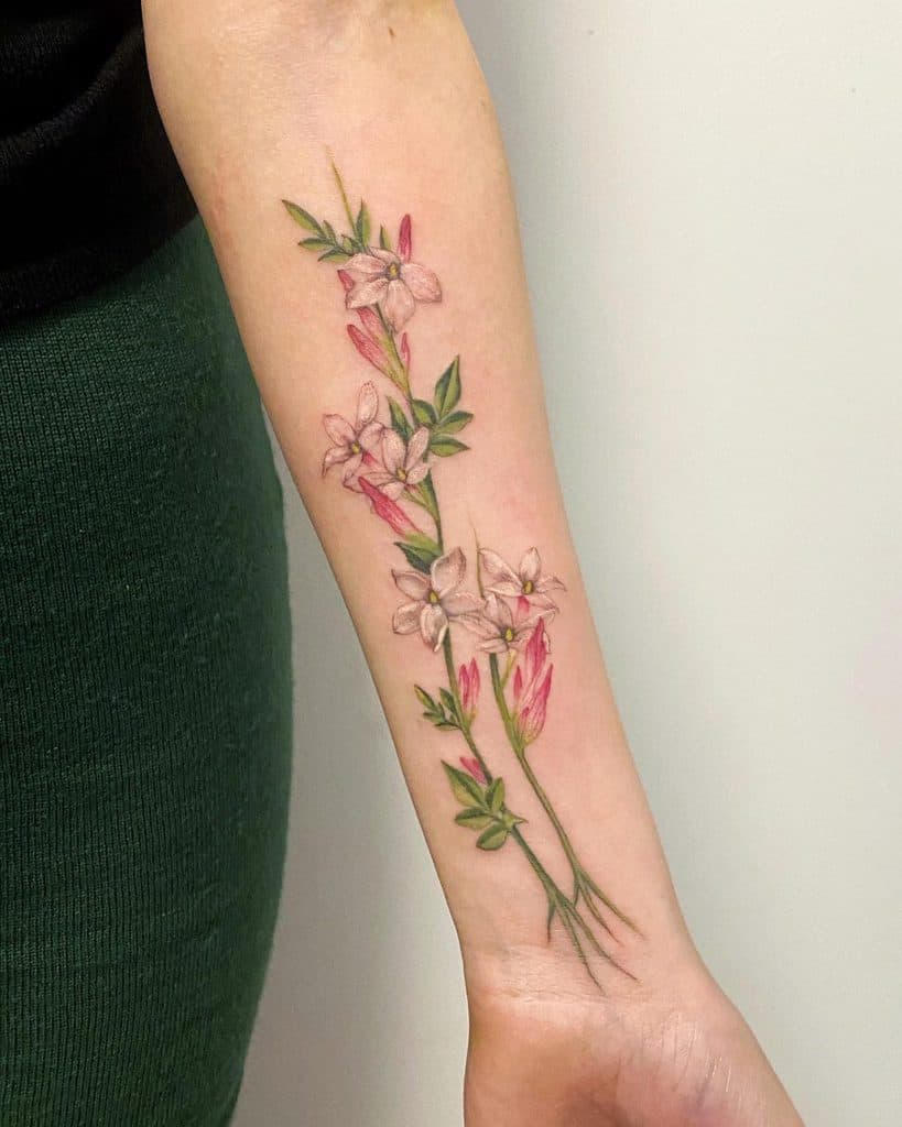 Colorful jasmine tattoo on the forearm for women