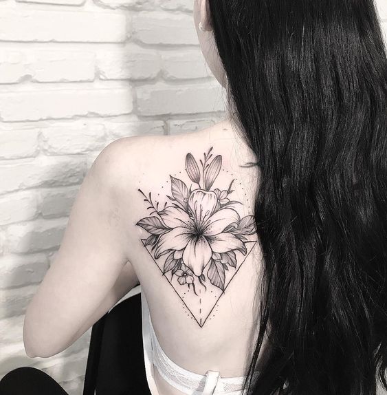 Lily tattoo on the back for women