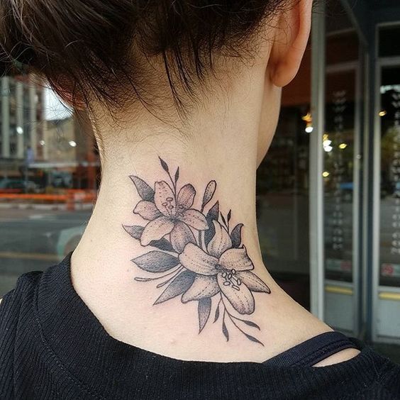 Tattoo of two lilies on the neck for women