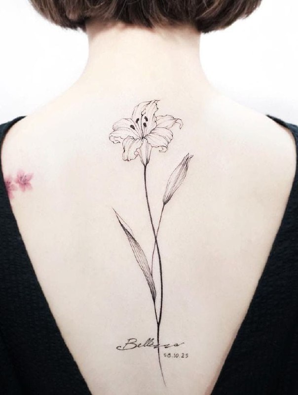 Large lily tattoo on the back for women