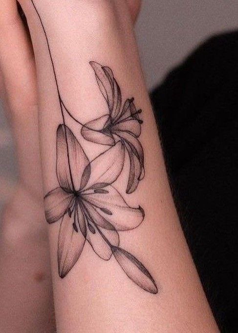 Lily tattoo on forearm for women