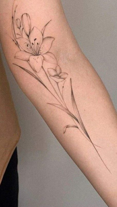 Lily tattoo on the arm for women