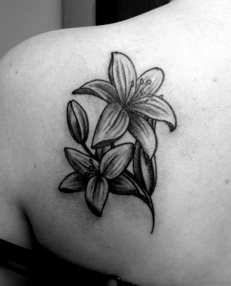 Lily tattoo on the shoulder blade for women