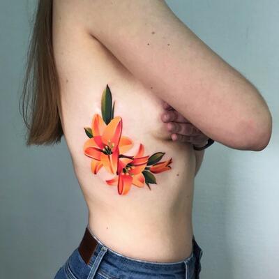 Colorful lily tattoo on the side for women