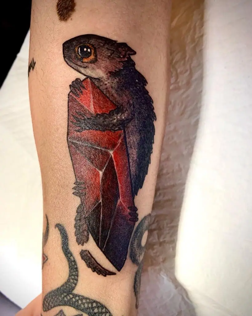 Colored lizard tattoo on the forearm for men