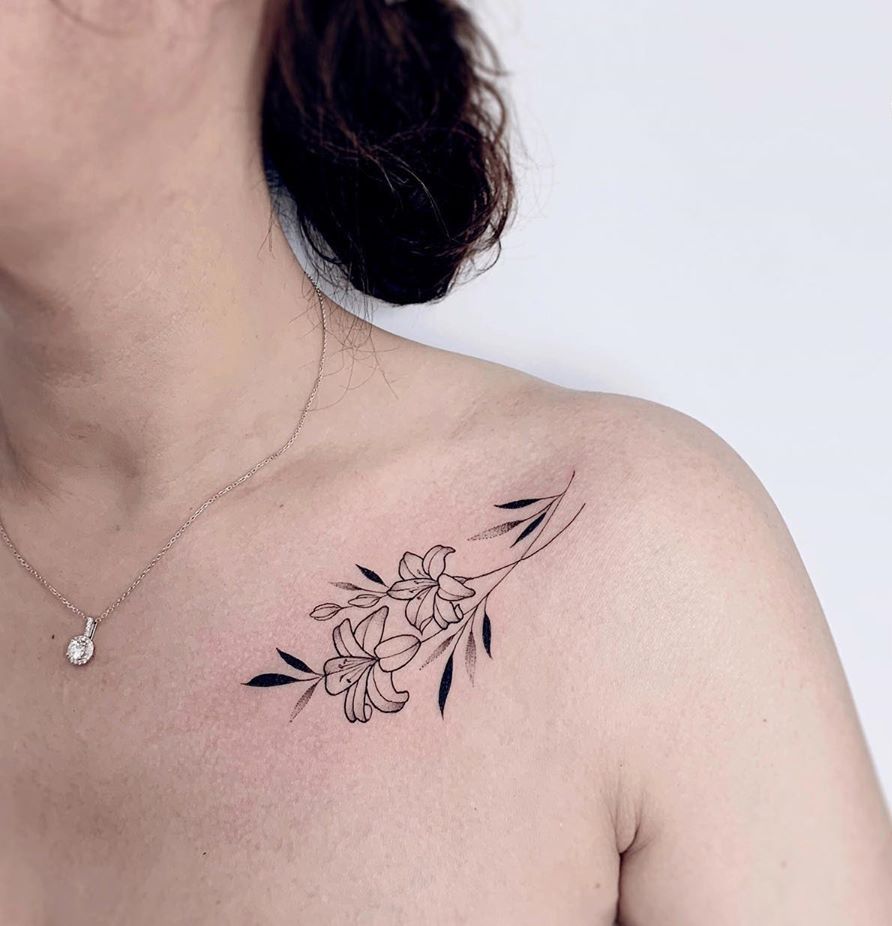 Small lotus tattoo on the collarbone for women