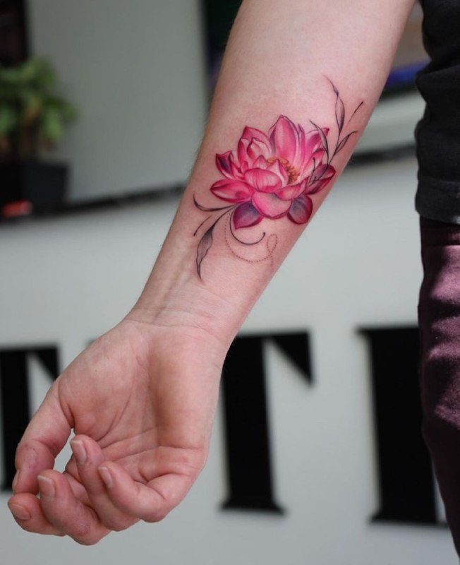 Colored lotus tattoo on the forearm for men