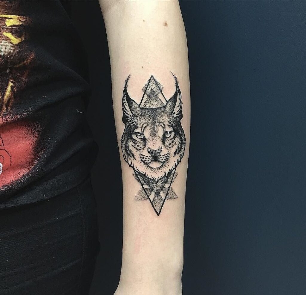 Lynx tattoo on the forearm for women