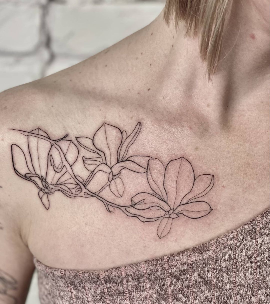 Orchid tattoo on the collarbone for women