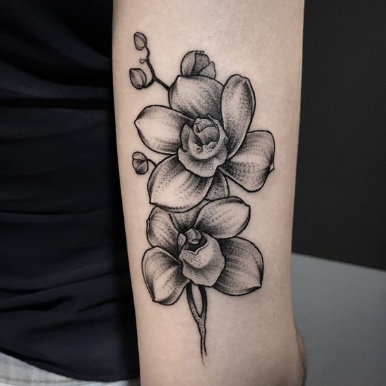 Large orchid tattoo on the forearm for women