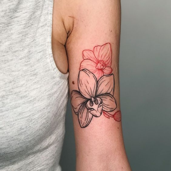 Color tattoo of an orchid on the shoulder for women