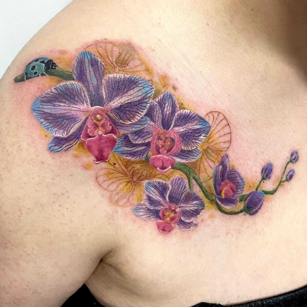 Large orchid tattoo on the collarbone for women