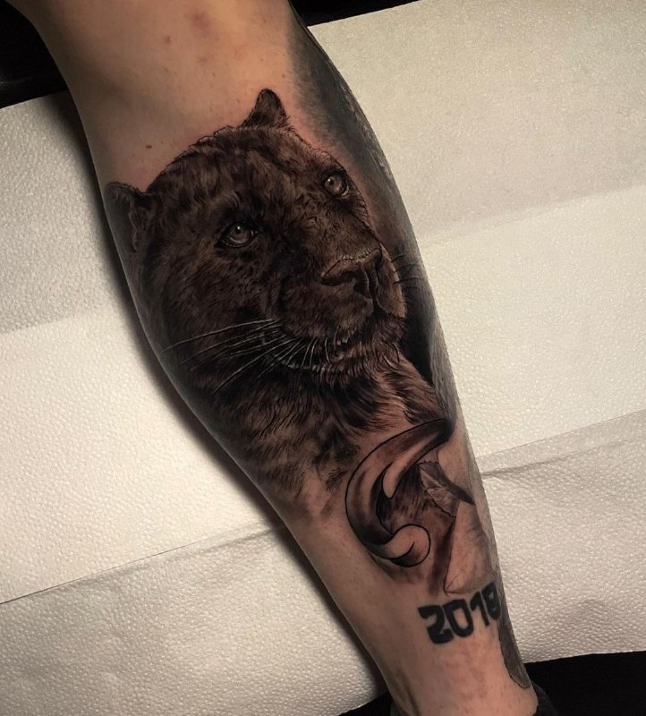 Panther tattoo on the shin for men