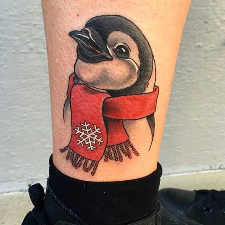 Tattoo of a penguin on the shin for men