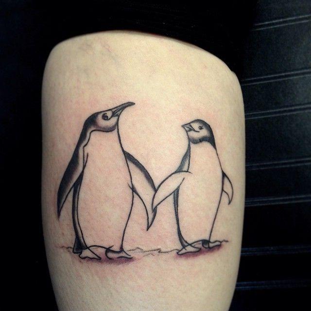 Tattoo of a penguin on the shoulder for men