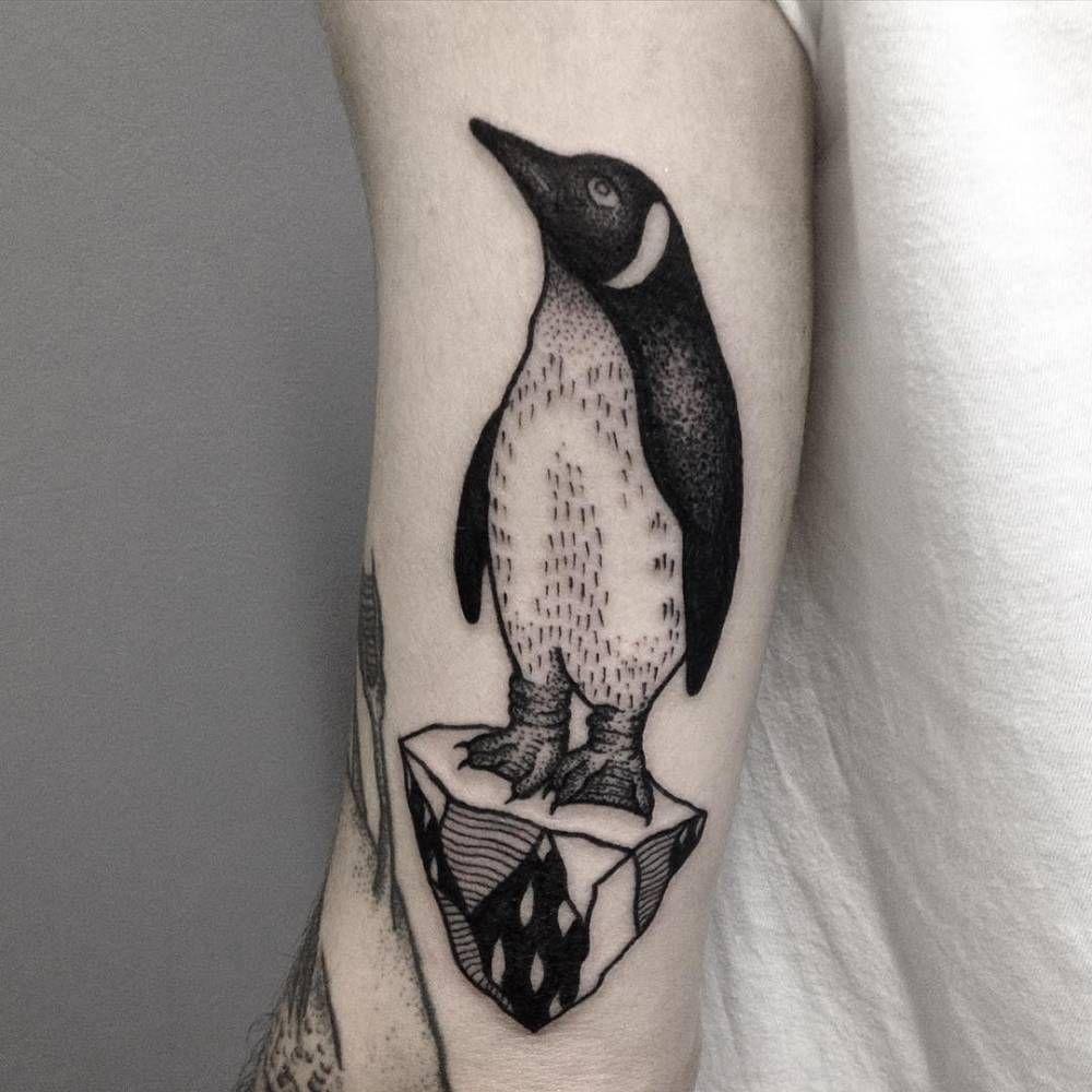 Tattoo of a penguin on the shoulder for men