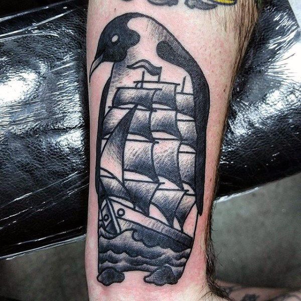 Tattoo of a penguin on the forearm for men