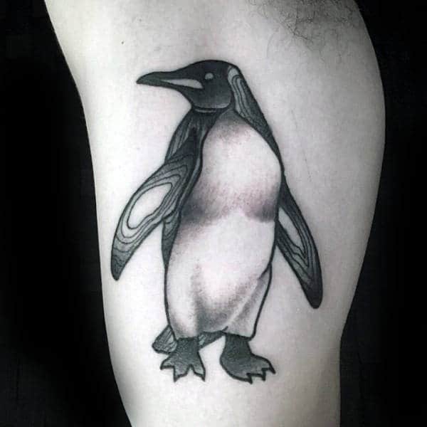 Tattoo of a penguin on the shoulder for men