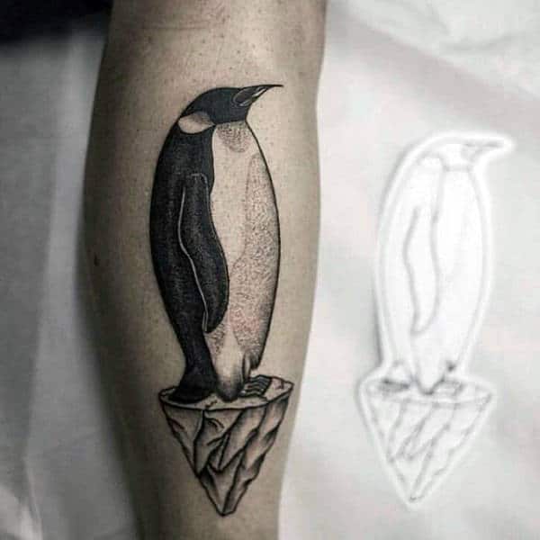 Tattoo of a penguin on the shin for men