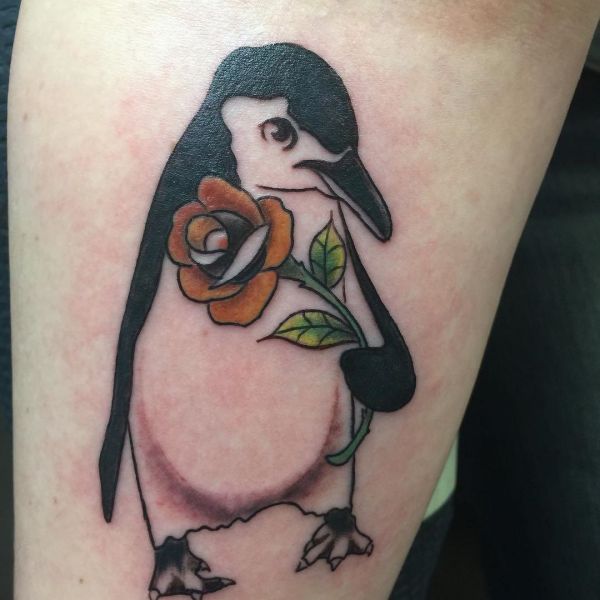 Tattoo of a penguin on the forearm for men