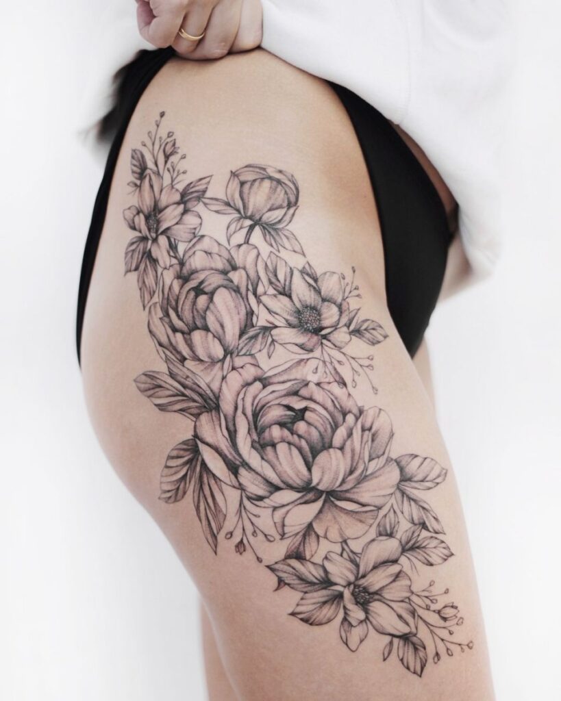 Large peony tattoo on the thigh for women