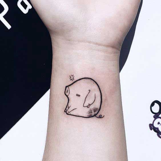 Pig tattoo on the arm for women