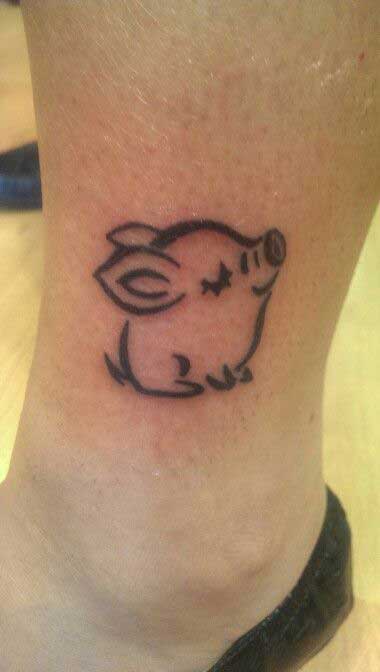 Tattoo of a pig on the ankle for women