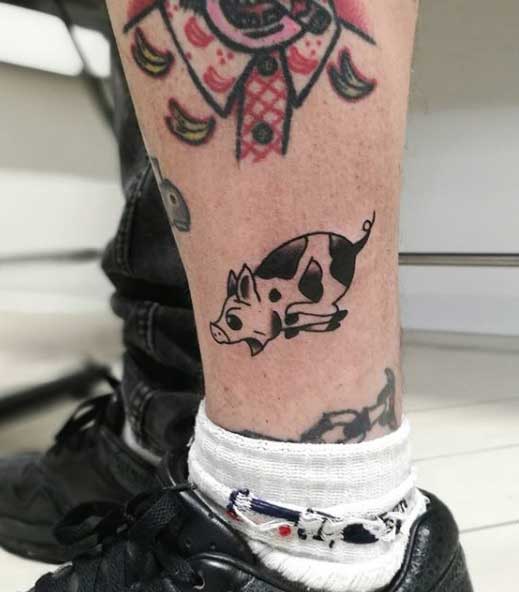 Pig tattoo on the shin for men