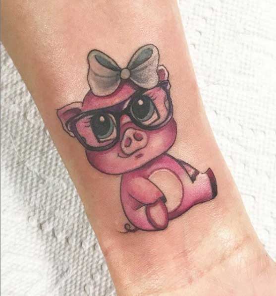 Pig tattoo on the forearm for women