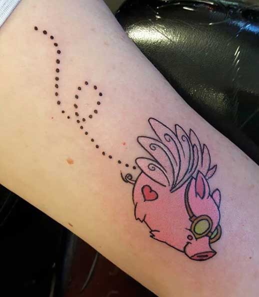 Pig tattoo on the forearm for women