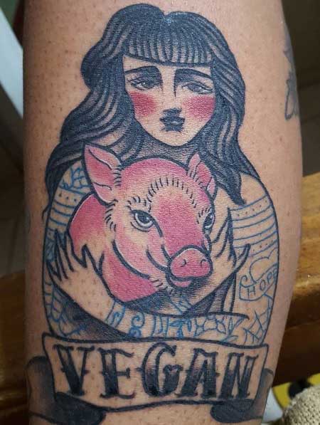 Pig tattoo on the shin for men