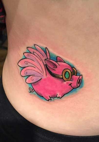 Pig tattoo on the side for women