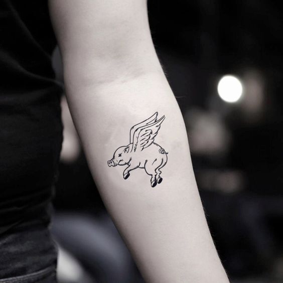 Pig tattoo on the forearm for women