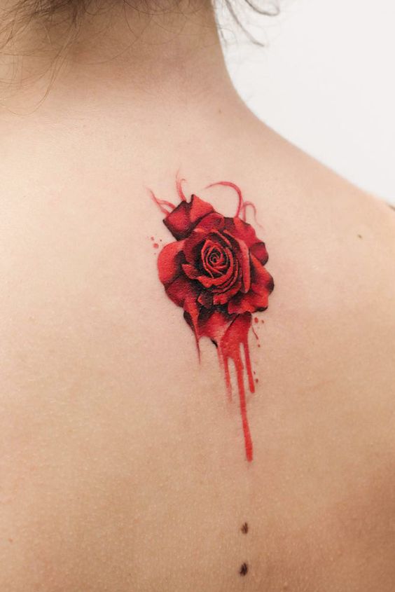 Little rose tattoo on the back for women