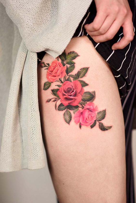 Colorful rose tattoo on the hip for women