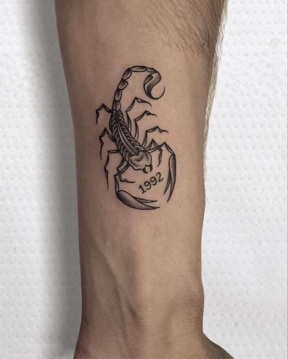 Tattoo of a scorpion on the forearm for men