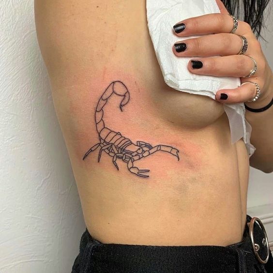 Scorpion tattoo on the side for women