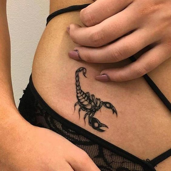 Tattoo of a scorpion on the stomach for women