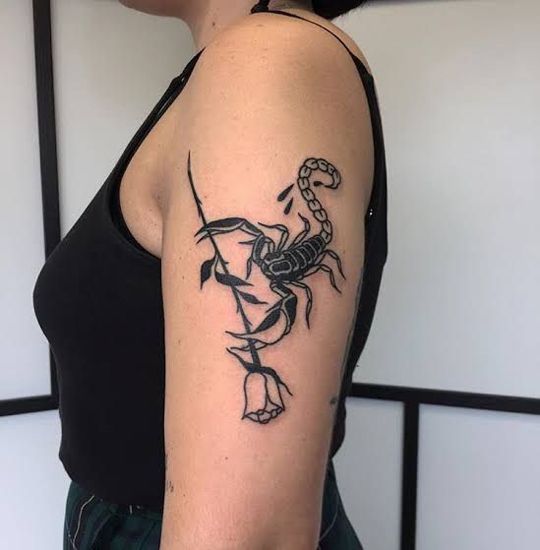 Tattoo of a scorpion with a rose on her shoulder for women