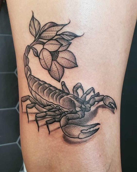 Tattoo of a scorpion on the shoulder for women