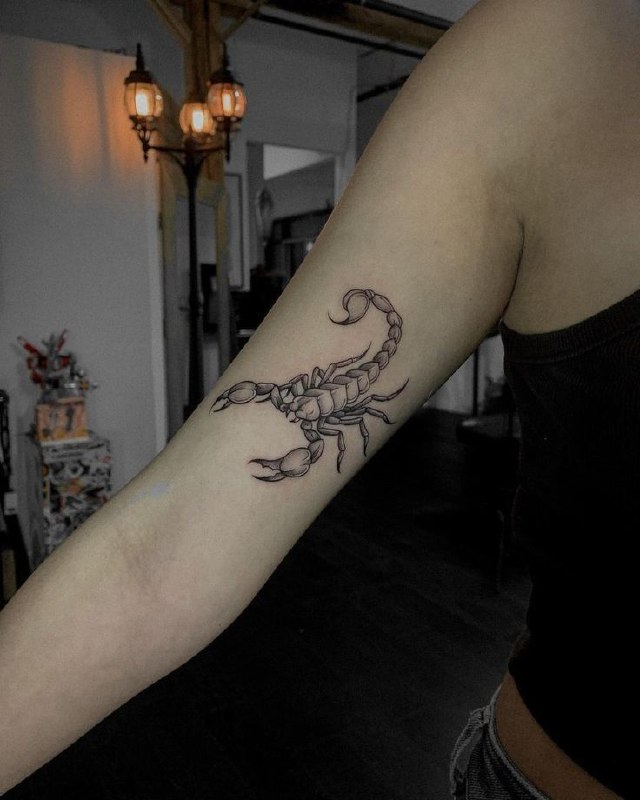 Tattoo of a scorpion on the shoulder for women