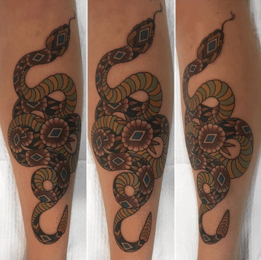 Tattoo of a colored rattlesnake on the arm for women