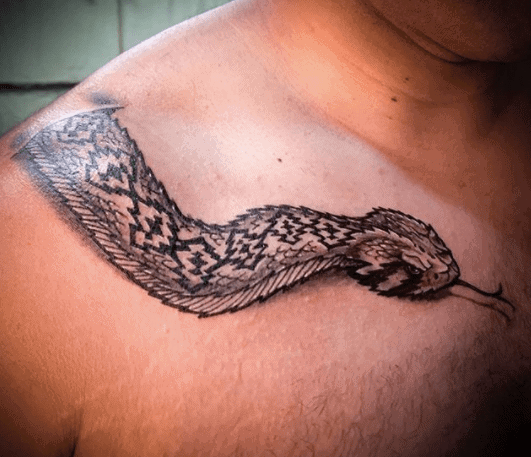 Rattlesnake tattoo on the collarbone for men