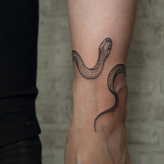 Snake tattoo on the forearm for men