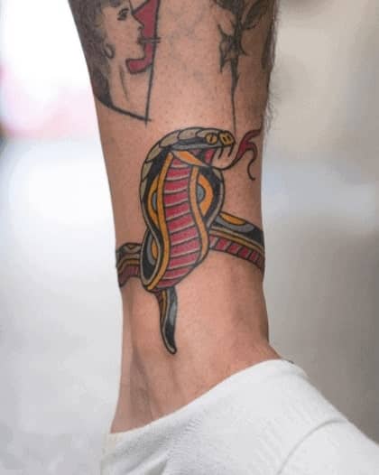 Snake tattoo on the shin for men