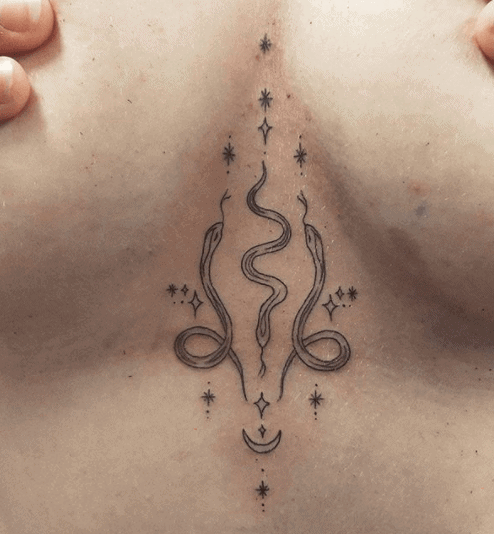 Tattoo of a small snake on the chest for women