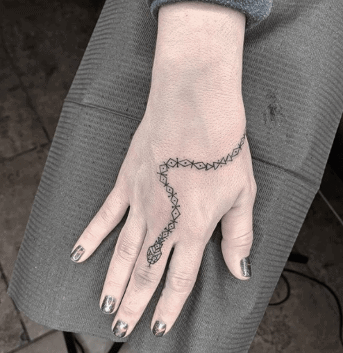 Snake tattoo on the hand for women