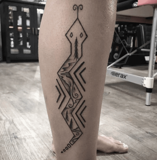 Snake tattoo on the shin for women