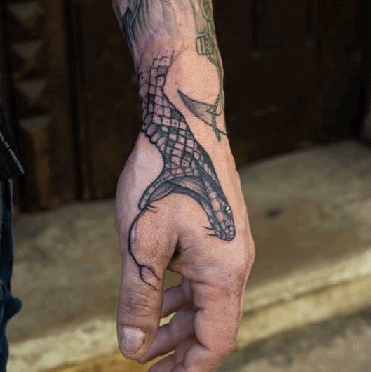 Snake head tattoo on the hand for men